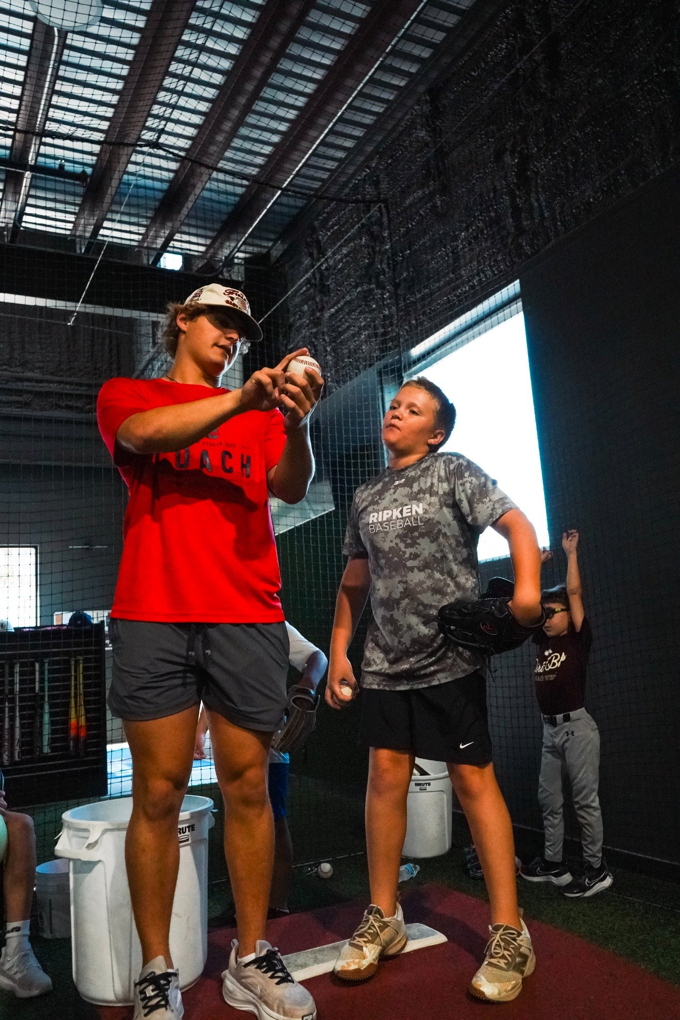 Coach demonstrating technique to an athlete at Lone Star Sports Zone