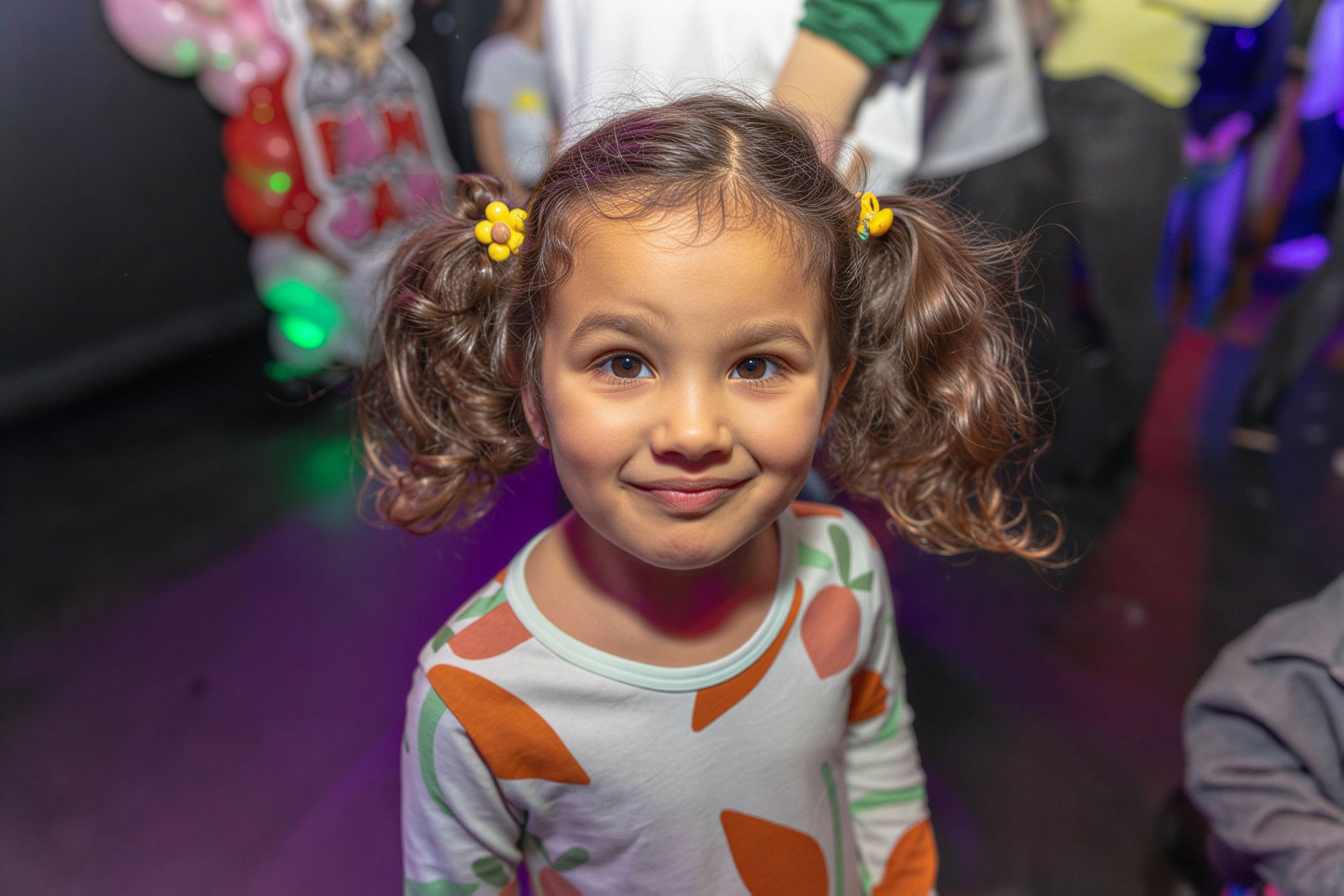 A smiling girl with pigtails at Fam Jam