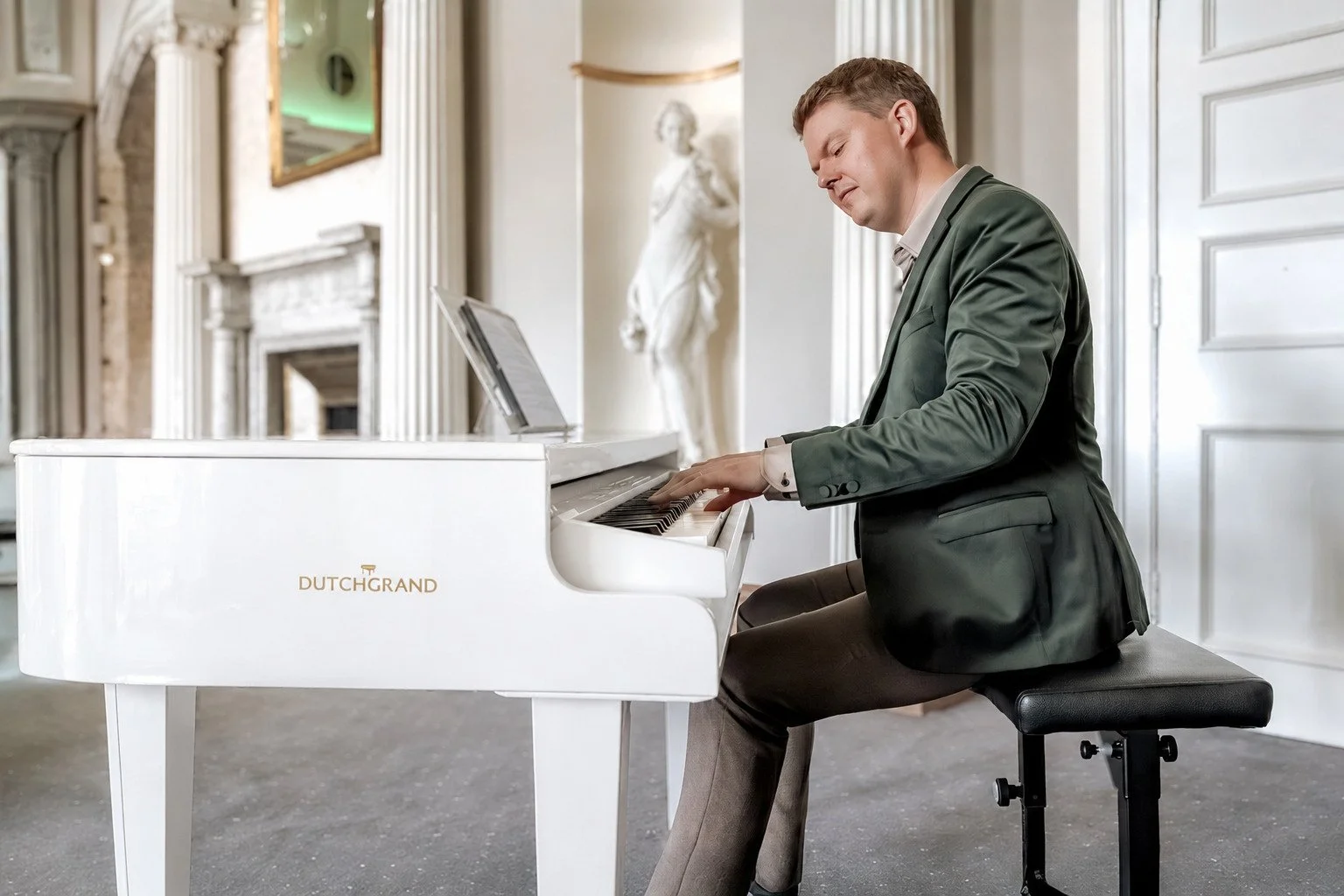 The same piano and pianist, with the piano in white