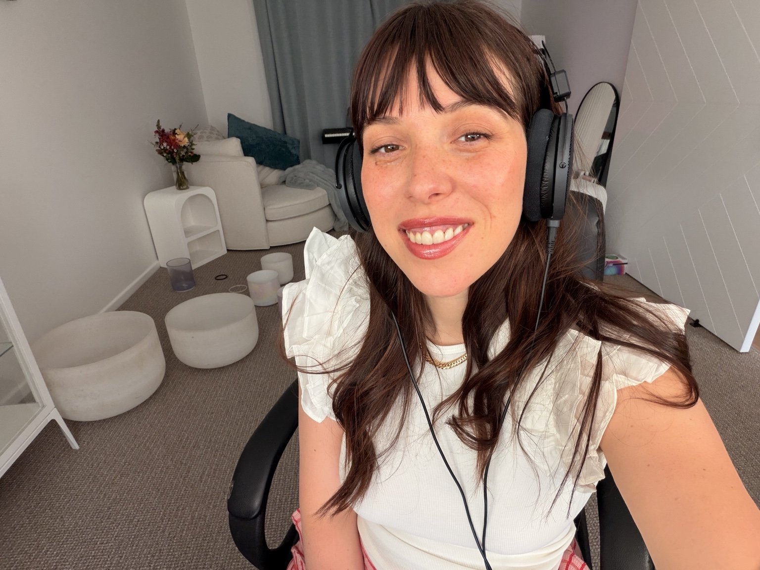Katie wearing headphones in her sound studio