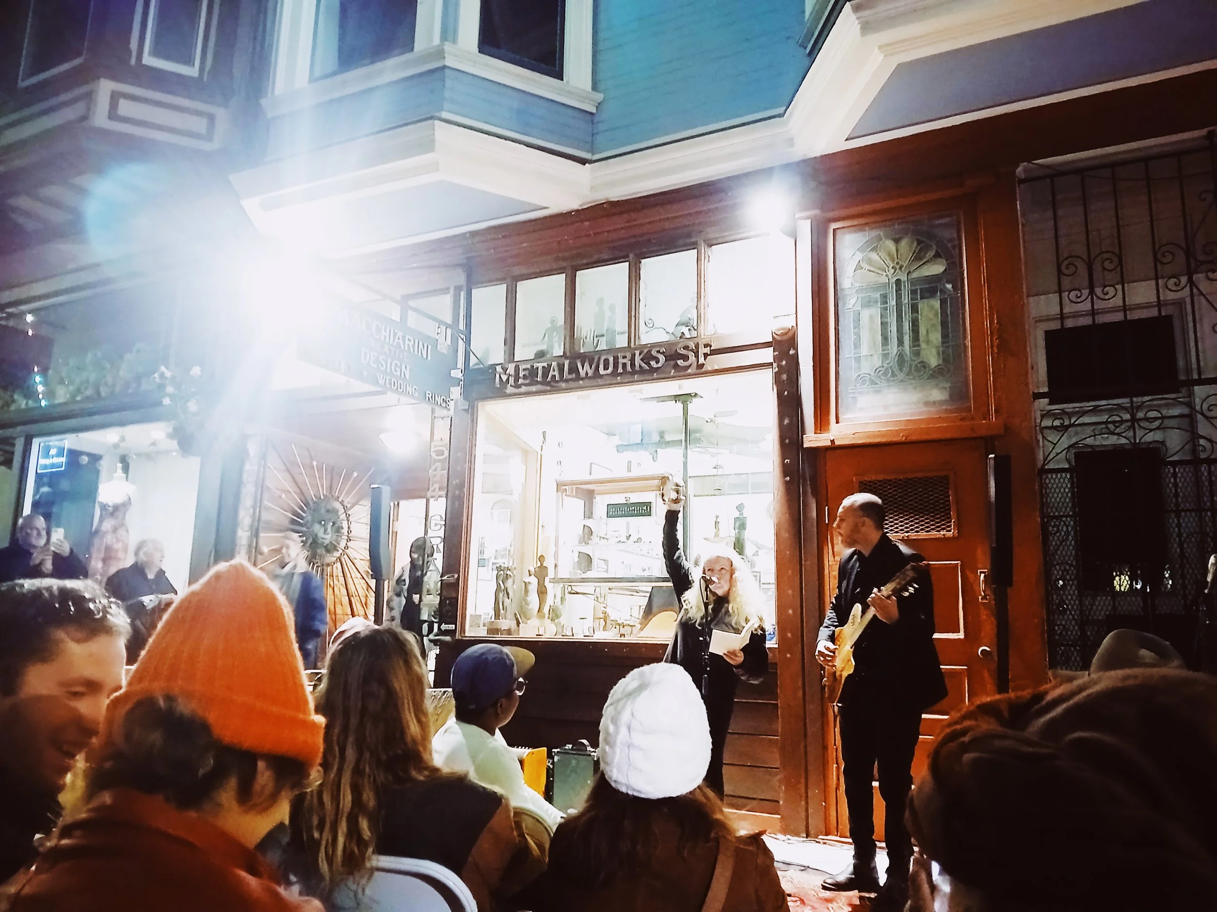 Jessica Loos reads and shakes a tambourine during the North Beach Poetry Crawl