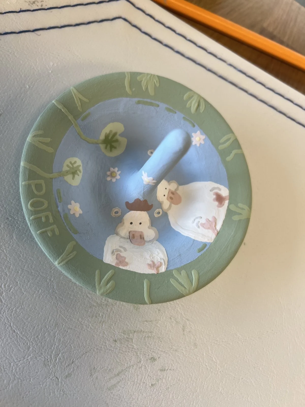 Hand-painted ring dish with cows, flowers, and a blue and green palette