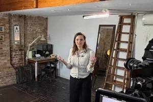 Jocelyn Burnham presenting to camera in a London studio during an Access Learning filming day