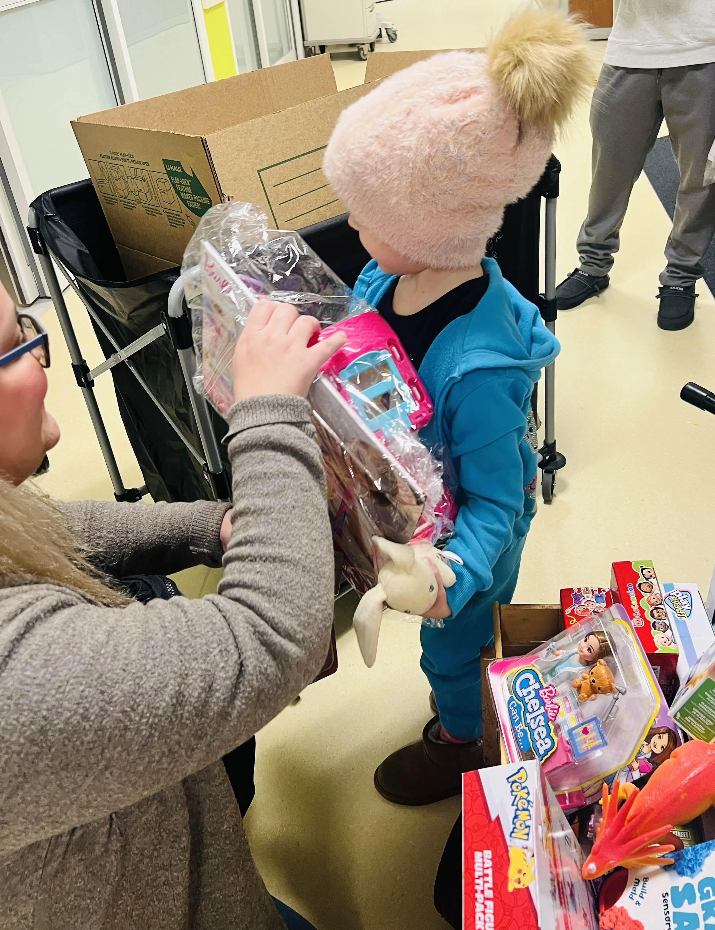 Child receiving a toy during cancer treatment