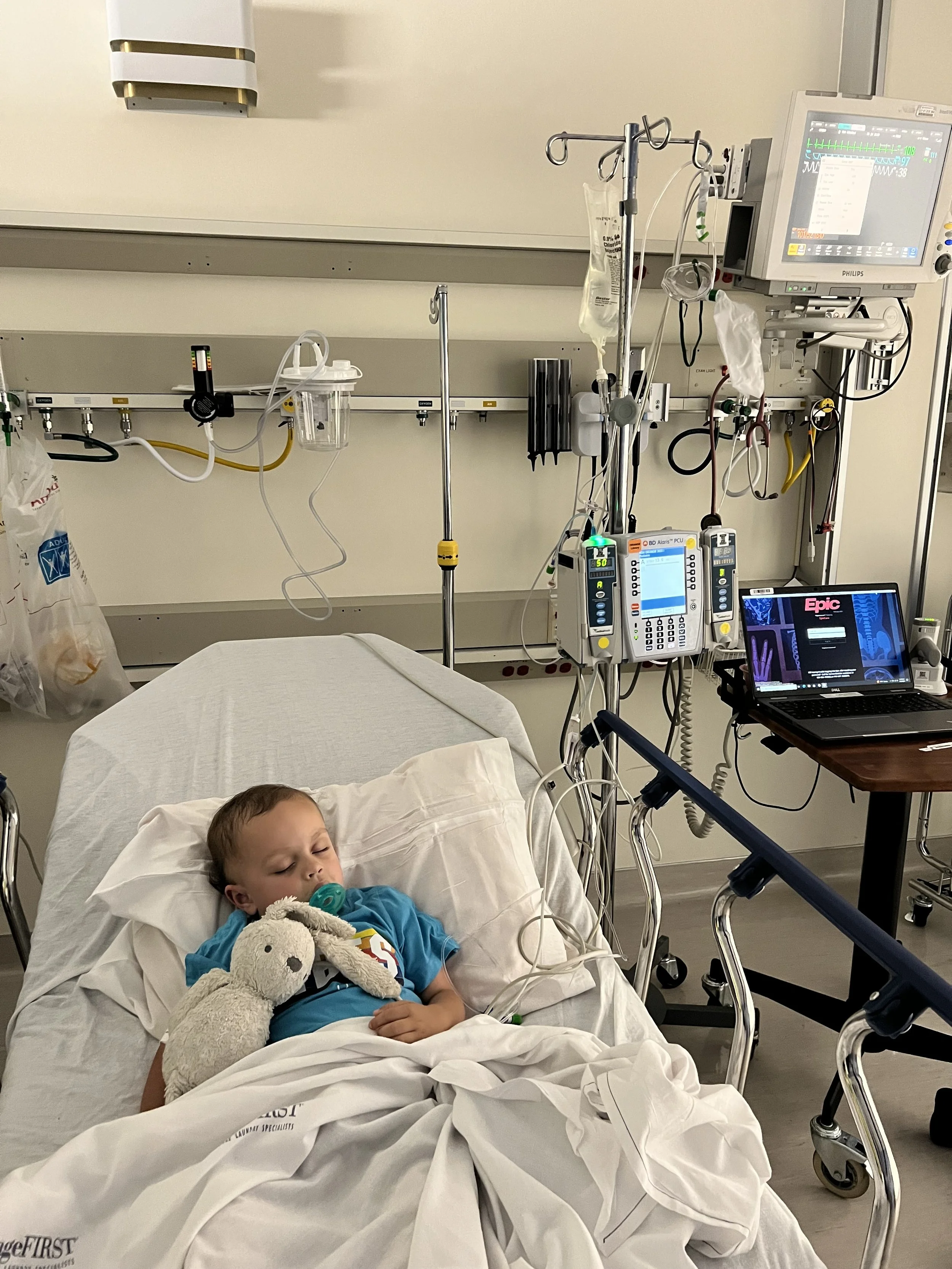Max in hospital holding a stuffed bunny