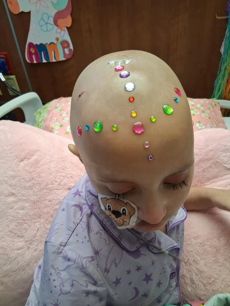 Annie with colorful stickers during treatment