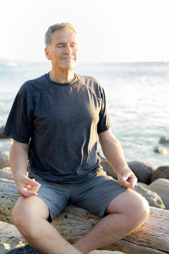 Detlef Joe Friede meditating by the ocean