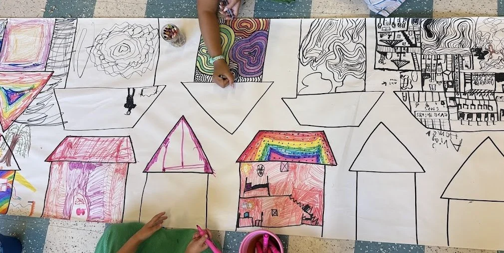 Children colouring together at a table during Summer Sessions at Naramata Centre