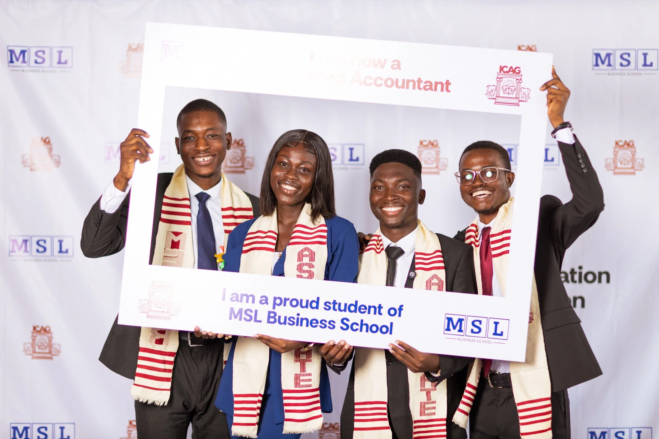 Four smiling MSL and ICAG students holding an MSL Business School achievement frame