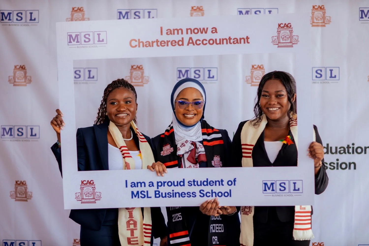 Three smiling female MSL Chartered Accountants celebrating together in front of an MSL and ICAG backdrop