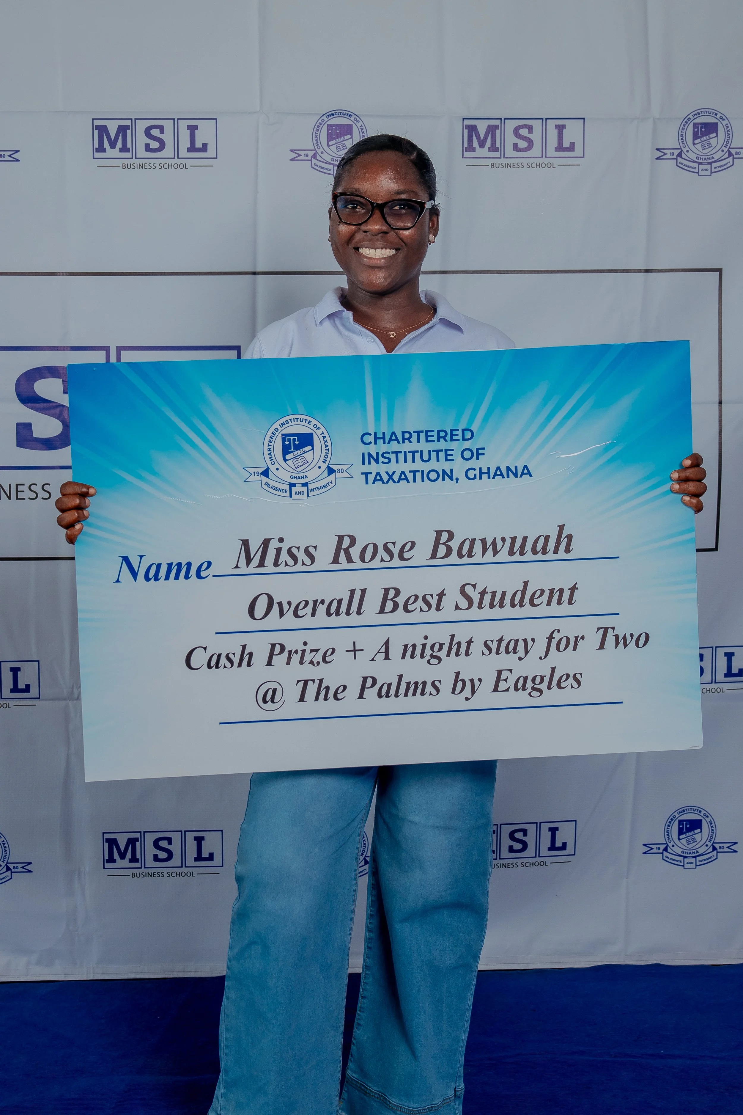 Abigail Cudjoe holding Rose Bawuah's National Overall Best Graduating Student award at the December 2025 CITG graduation, as Rose was abroad