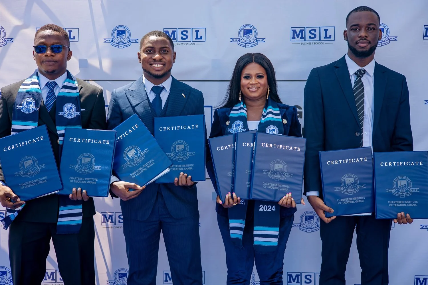 Male and female CITG graduates from MSL Business School in front of an MSL backdrop