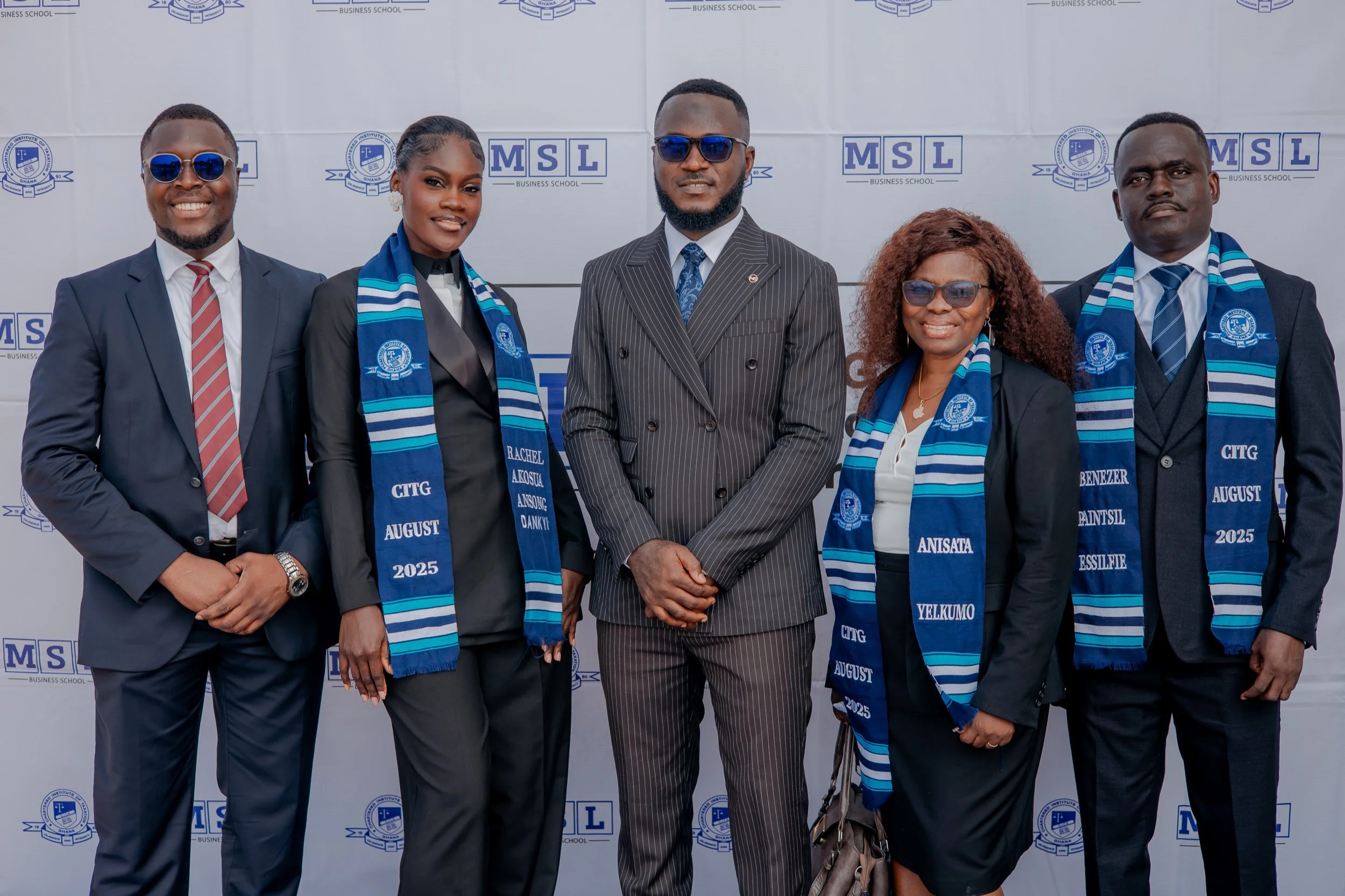 Five members of the MSL community celebrating a CITG professional milestone in front of an MSL and CITG backdrop