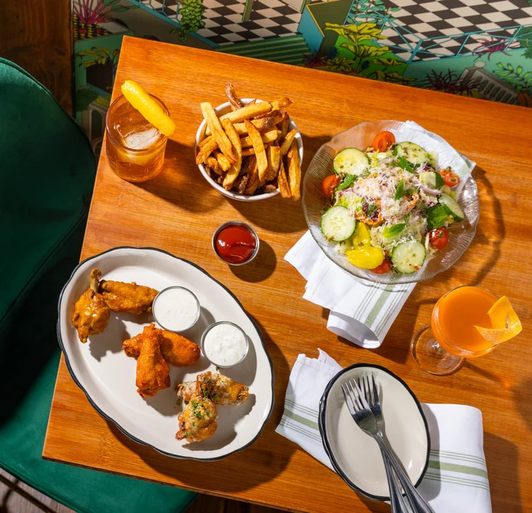 Catering spread with wings and salad