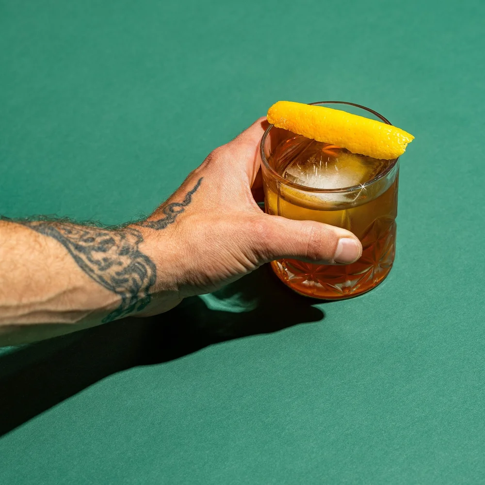 Cocktail raised for a toast at a wedding after-party at The Babe
