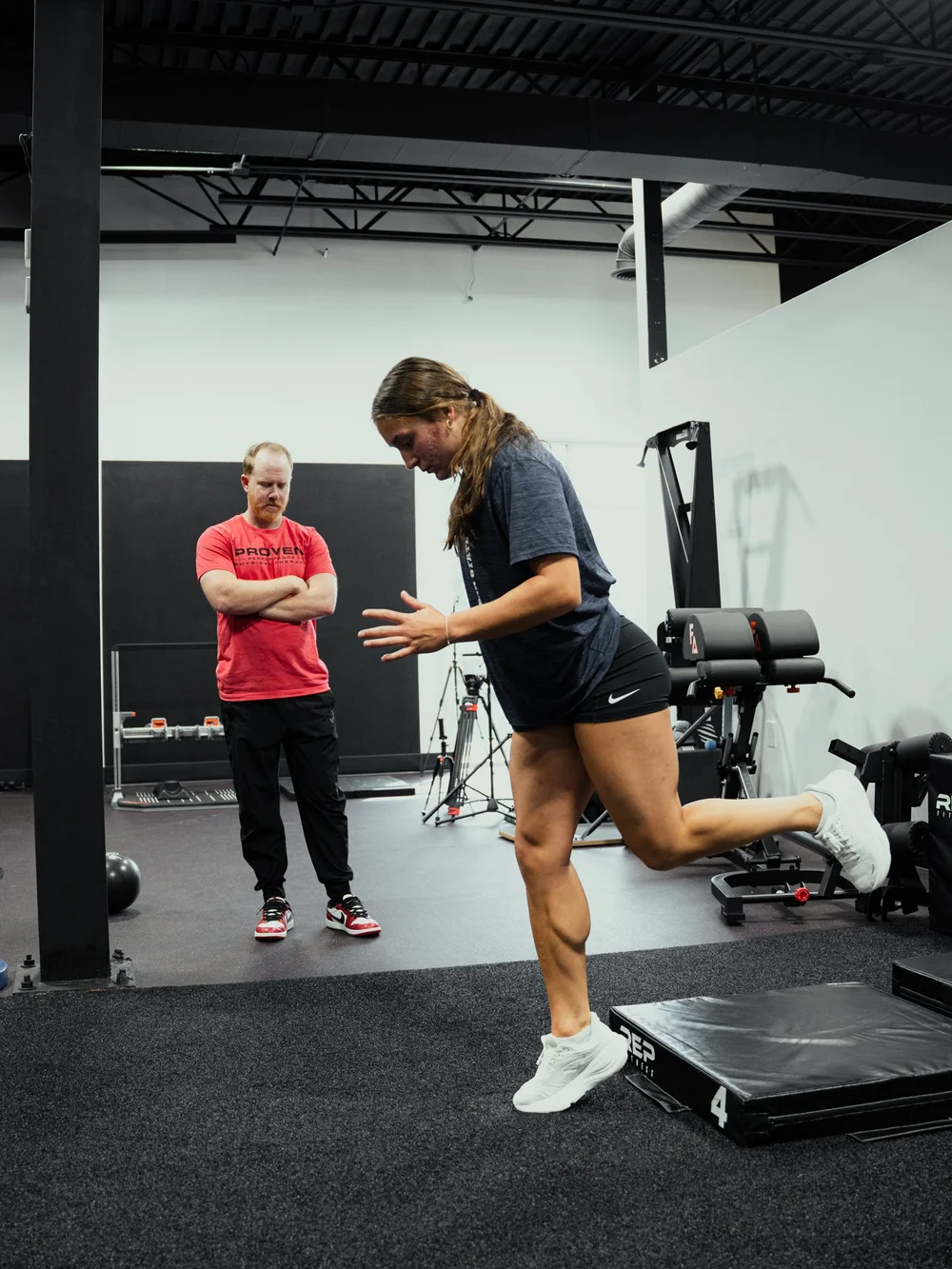 Athlete performing a single-leg jump drill while a Proven clinician observes