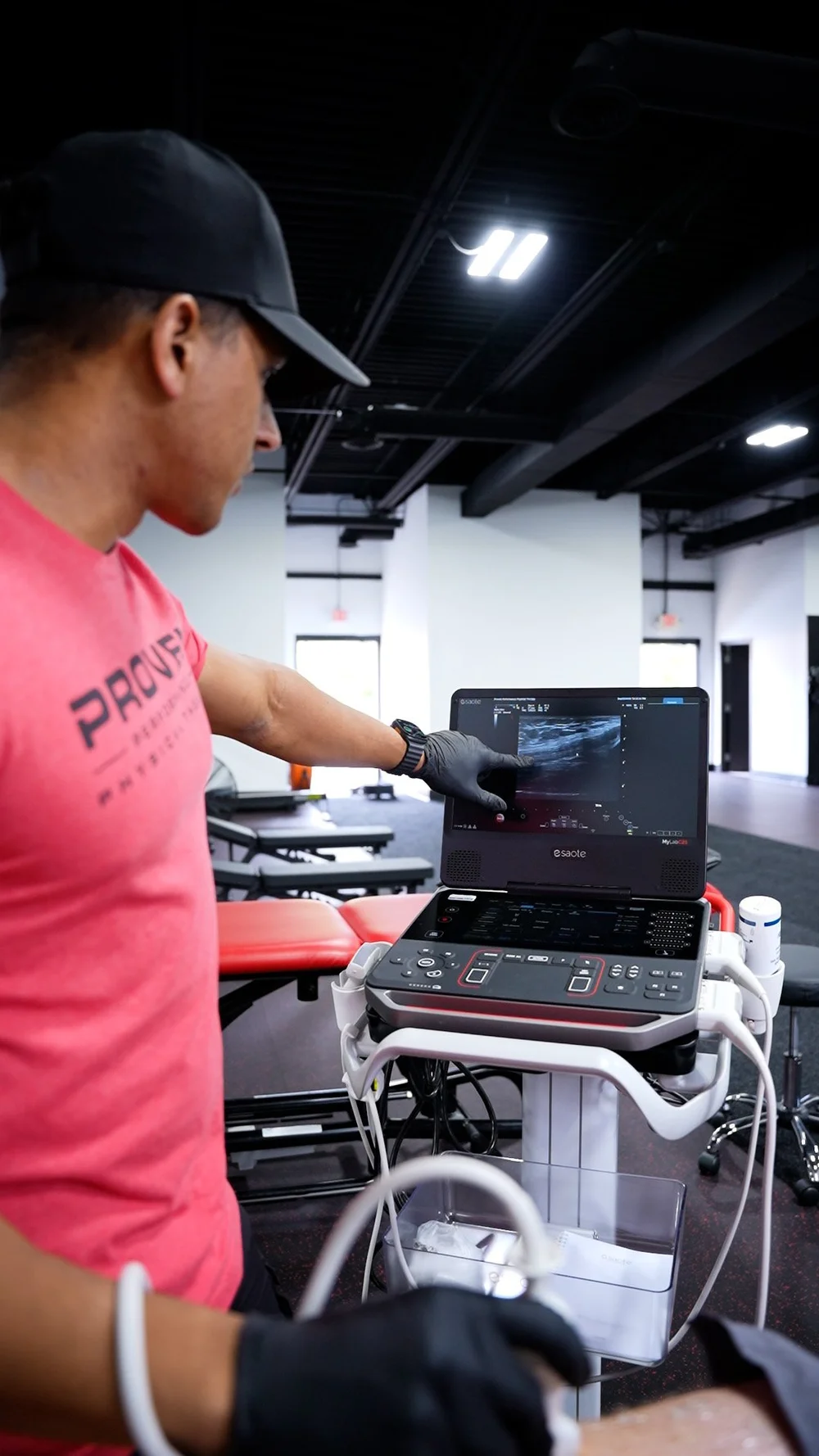 Proven physical therapist pointing to an ultrasound image on screen