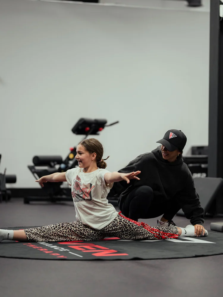 Clinician working with a young athlete on mobility