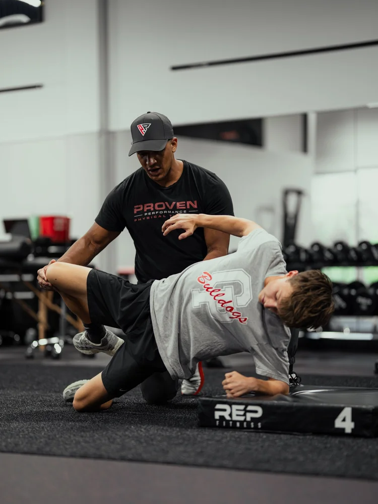 Clinician coaching an athlete through a mobility drill
