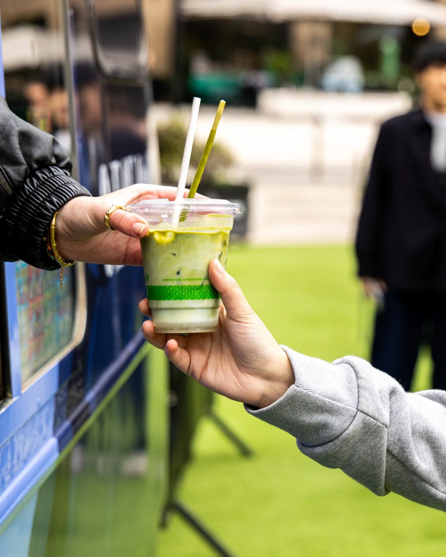 A Japanese-inspired matcha drink handed over at the ONE OK ROCK truck