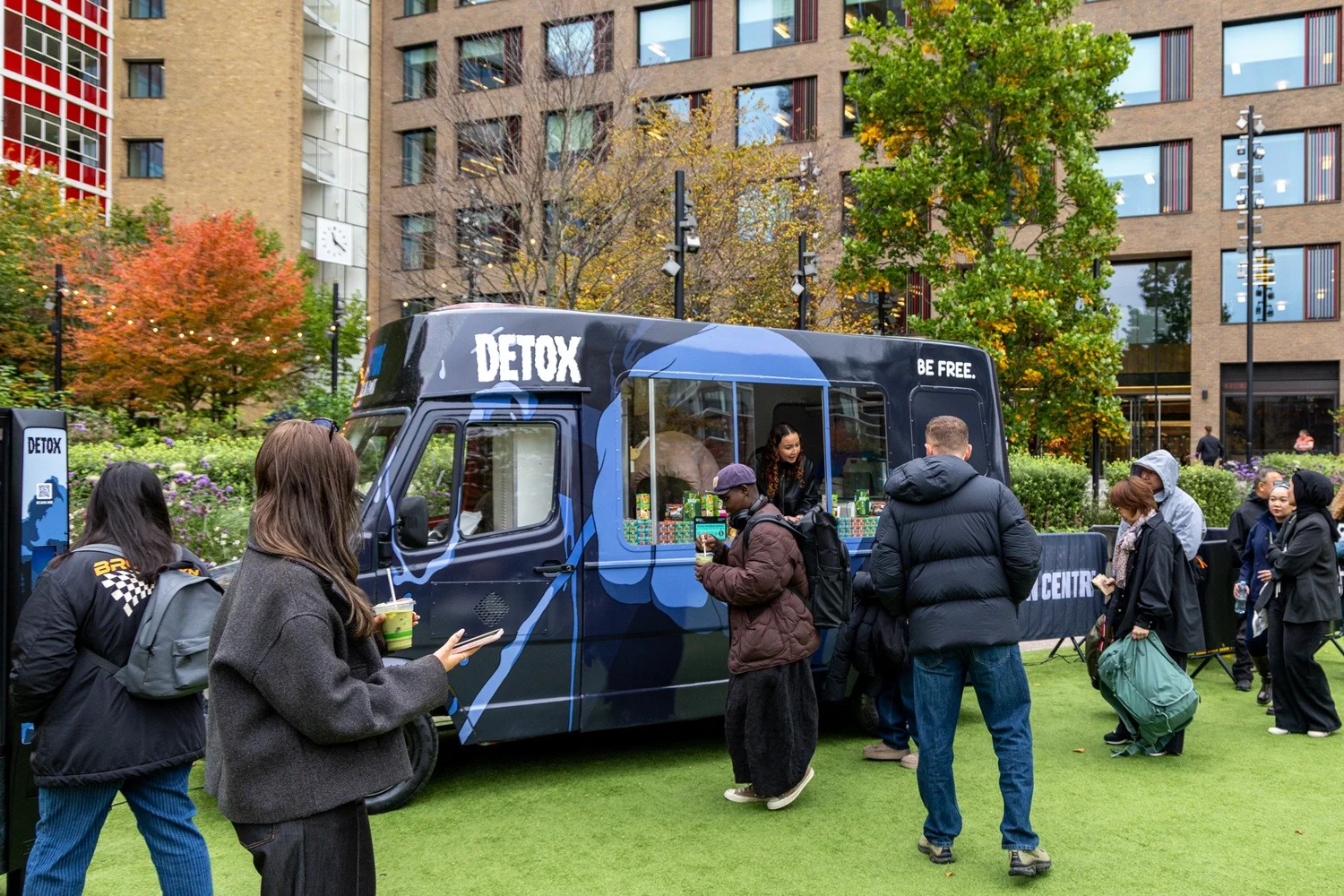 Blue ONE OK ROCK DETOX Mercedes promotional truck at an outdoor fan event