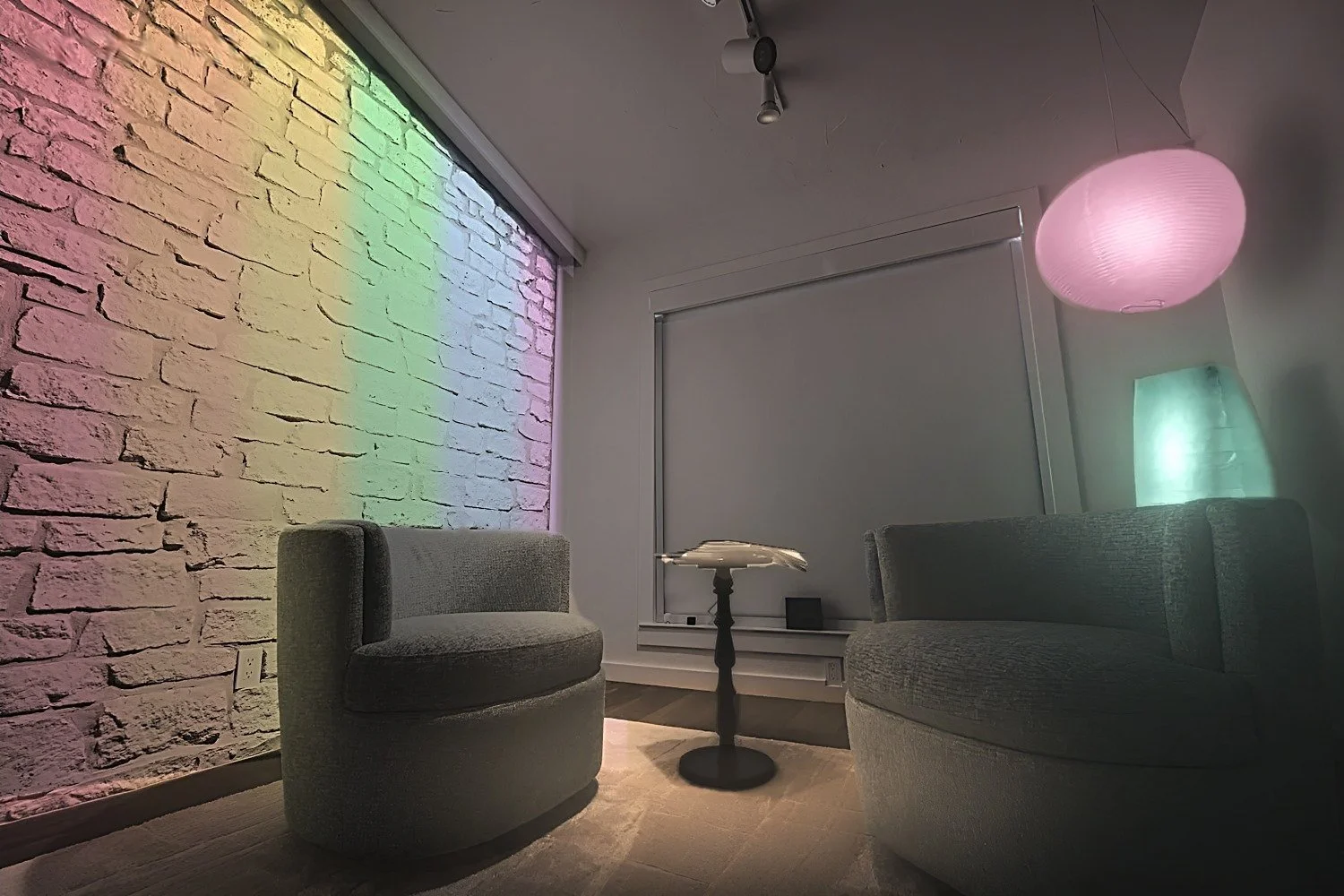 Showroom lounge with the stone wall washed in Ketra color