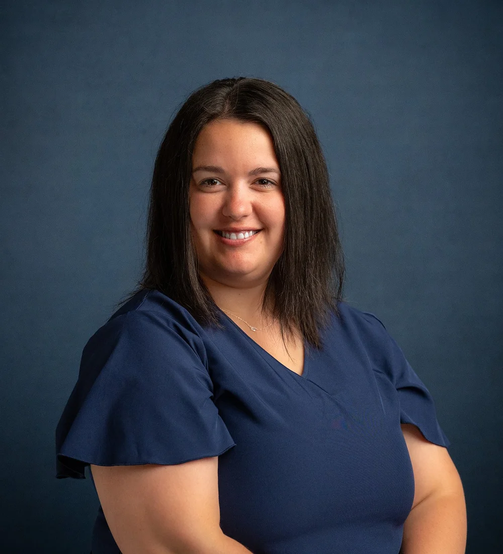 Commercial State Bank employee photographed against a consistent blue background in Wausa