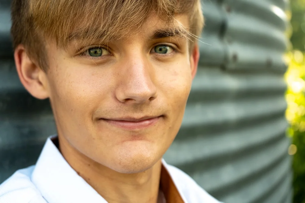A close-up of Gavin smiling during his senior portrait session.