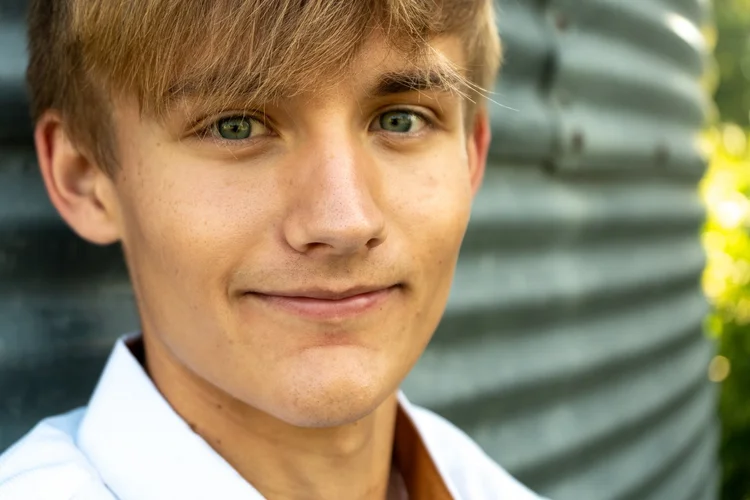 Close-up of Gavin smiling during his senior portrait session