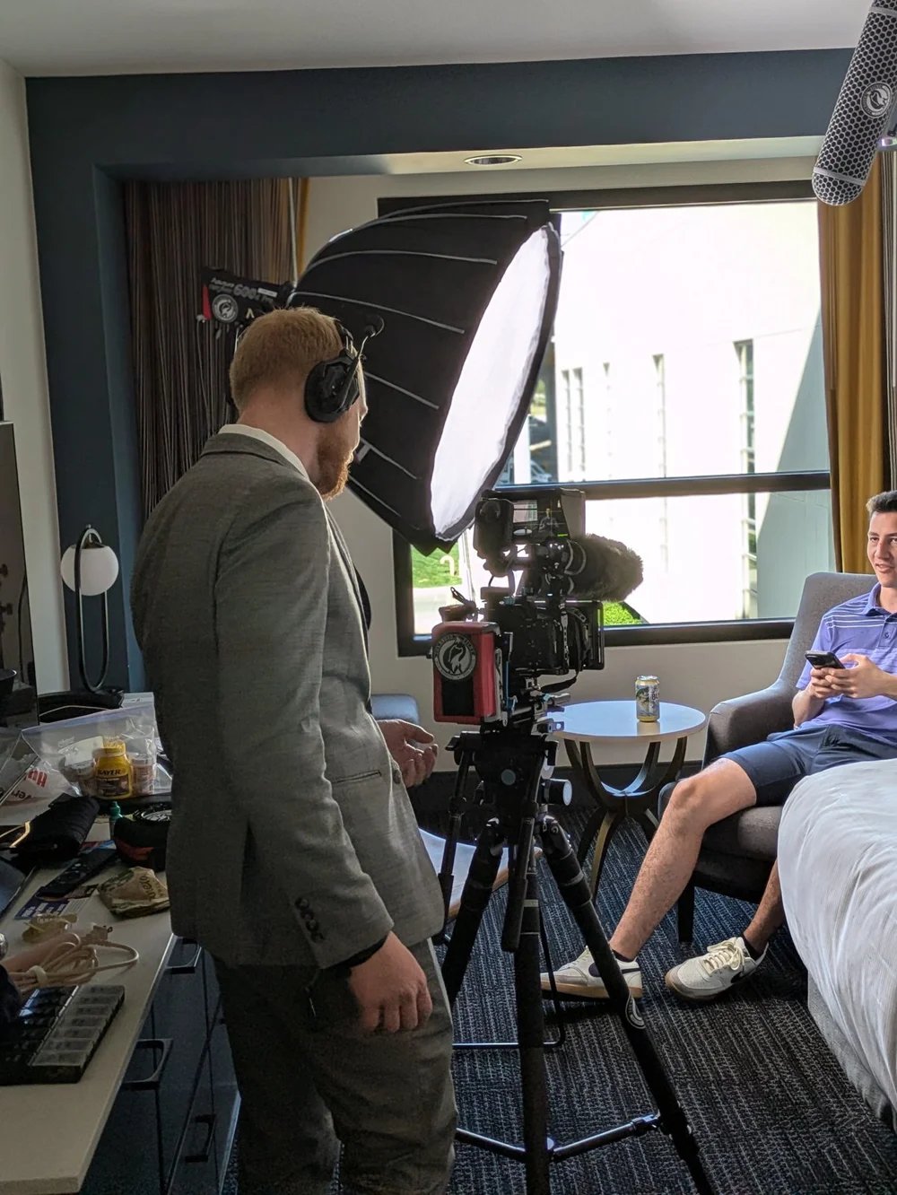Trevor recording Alex’s wedding-morning interview with a cinema camera, softbox and boom microphone.