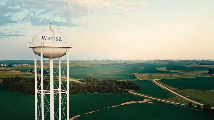 The Wausa water tower and surrounding Nebraska farmland in evening light