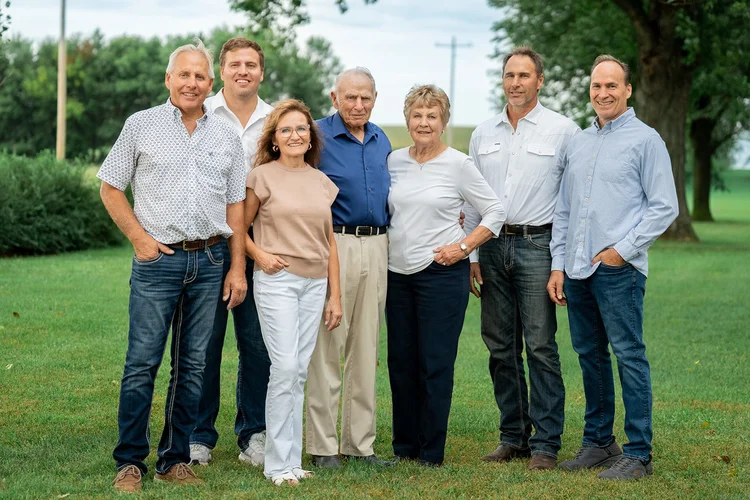 Seven members of the Kumm family standing together outdoors.