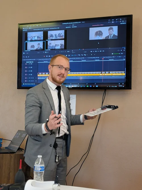 Trevor teaching video editing with a film timeline on screen at Fox Brush Films.