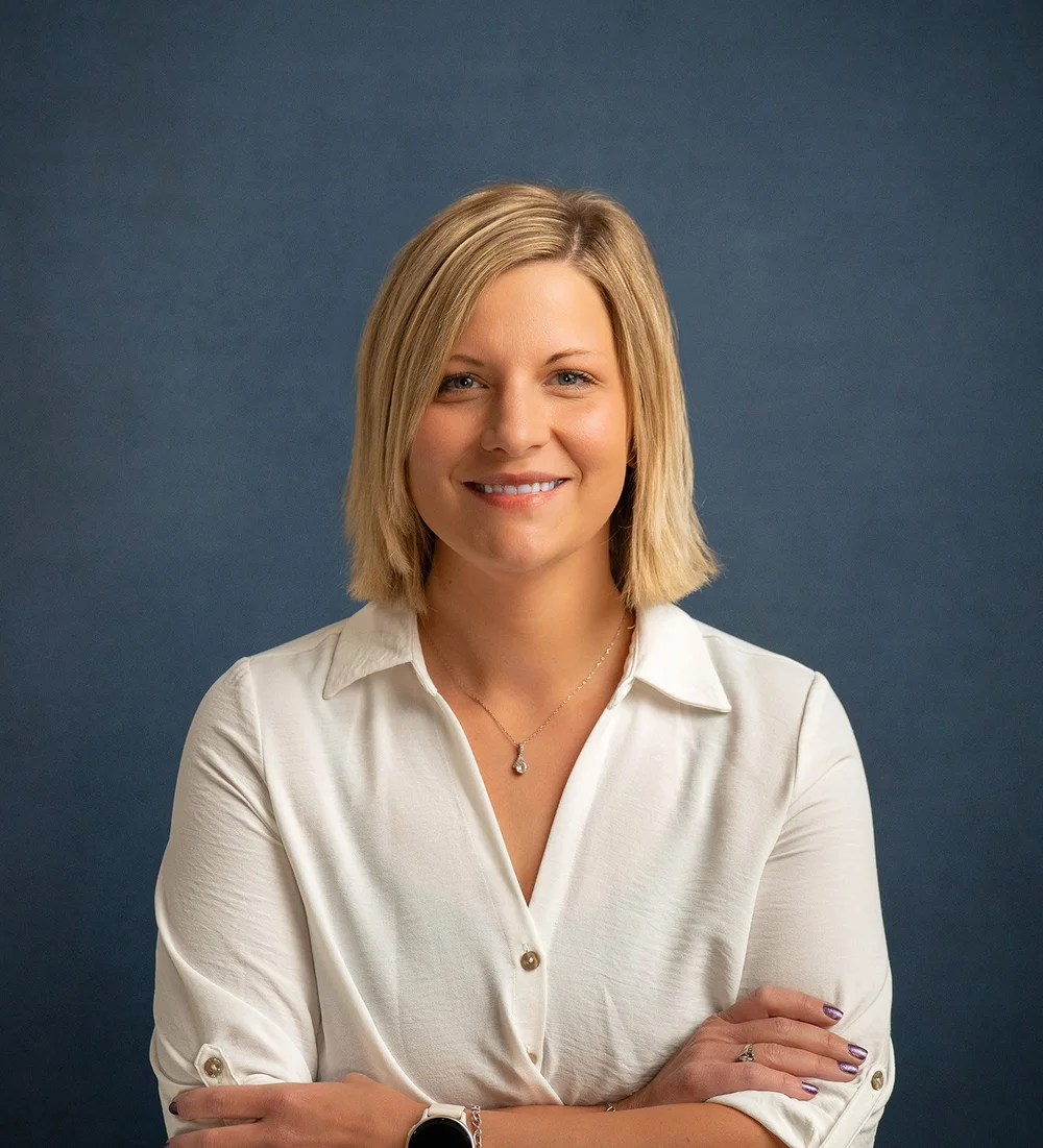 Rachel from Commercial State Bank photographed in a light blouse against a blue studio backdrop in Wausa Nebraska