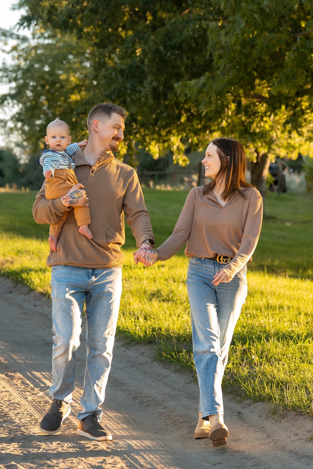 A family walking with their child during an autumn mini session.