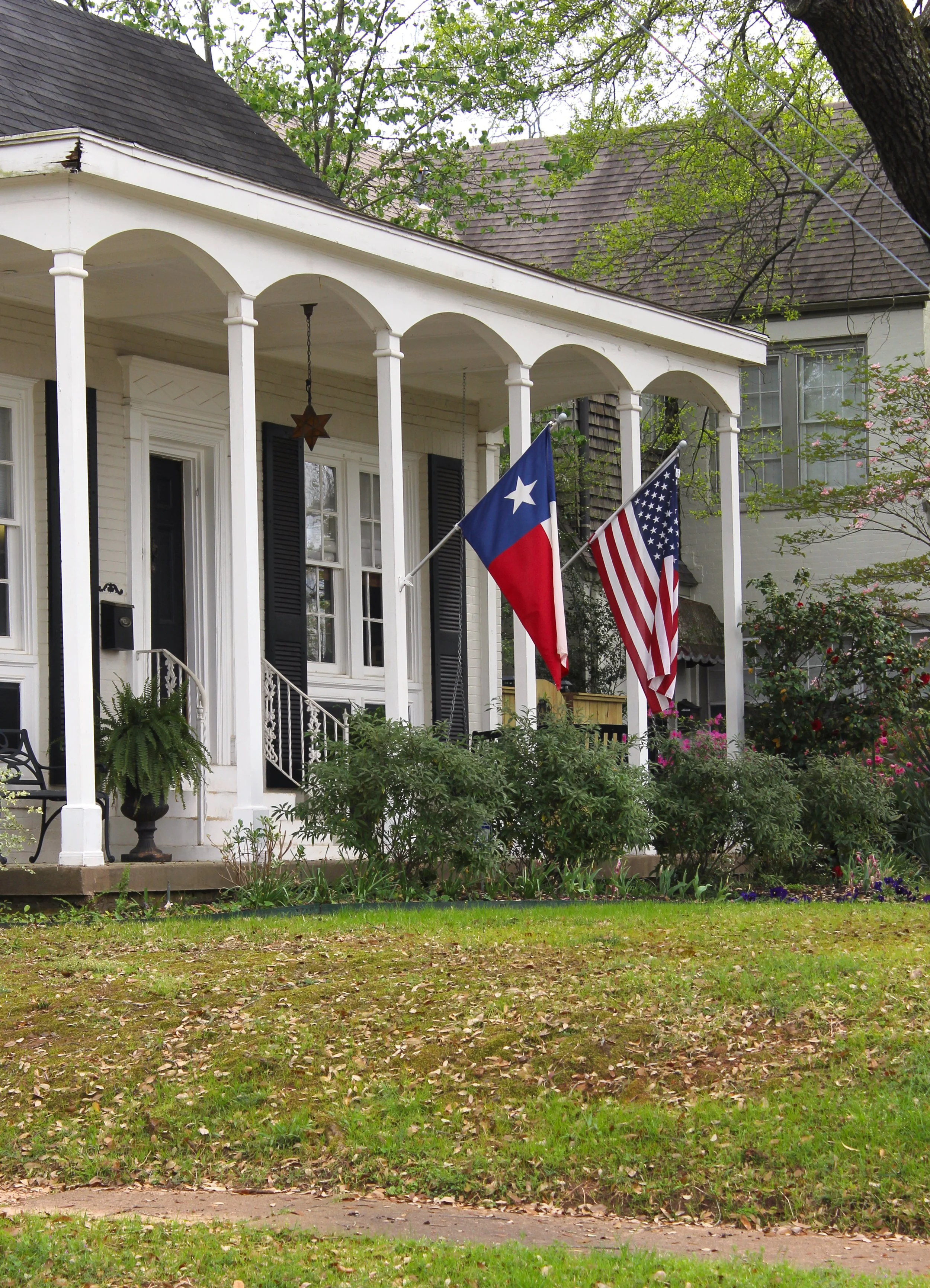 Historic Texas home with flags