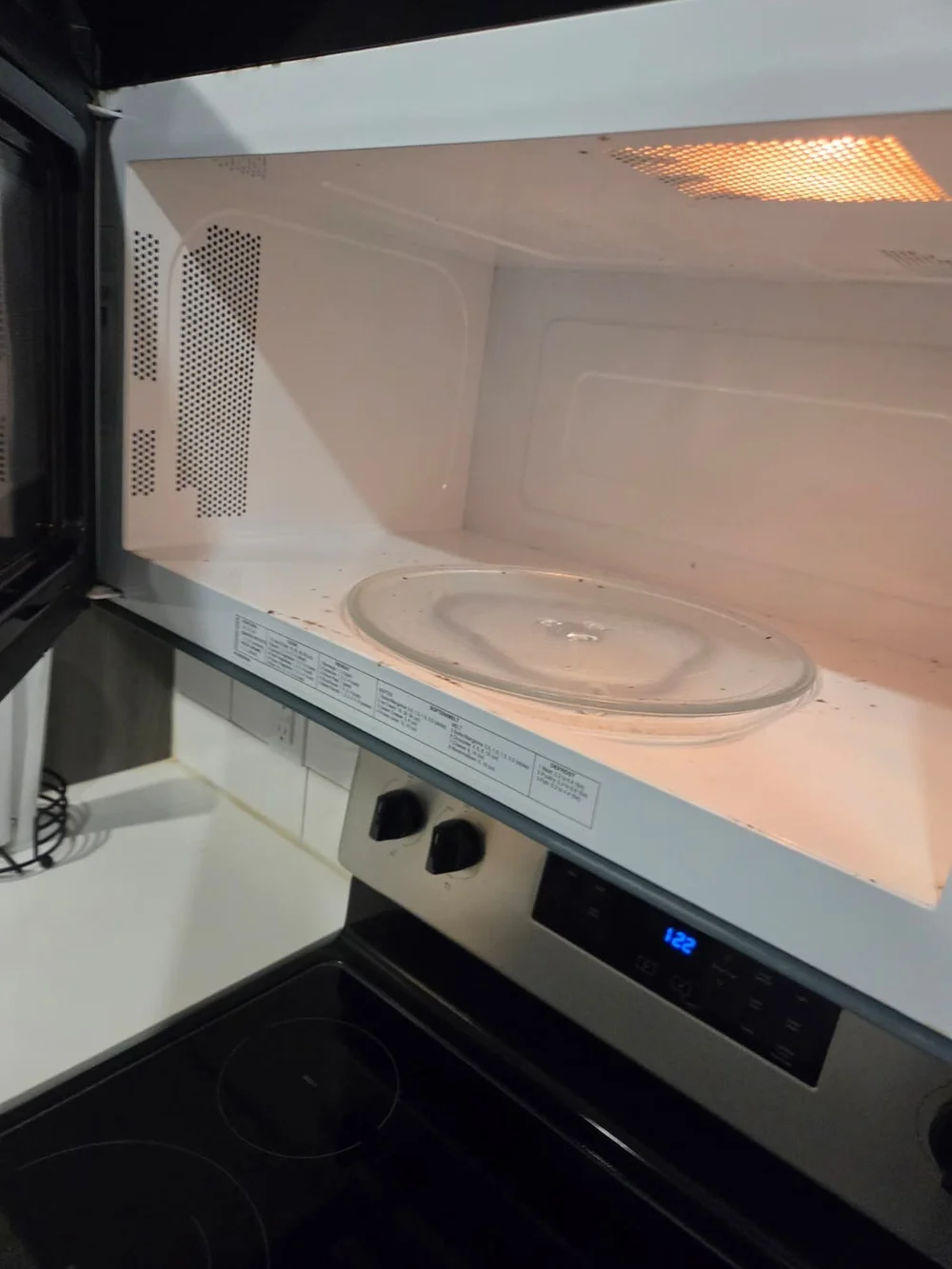 Before: microwave interior with food splatter in an Austin kitchen