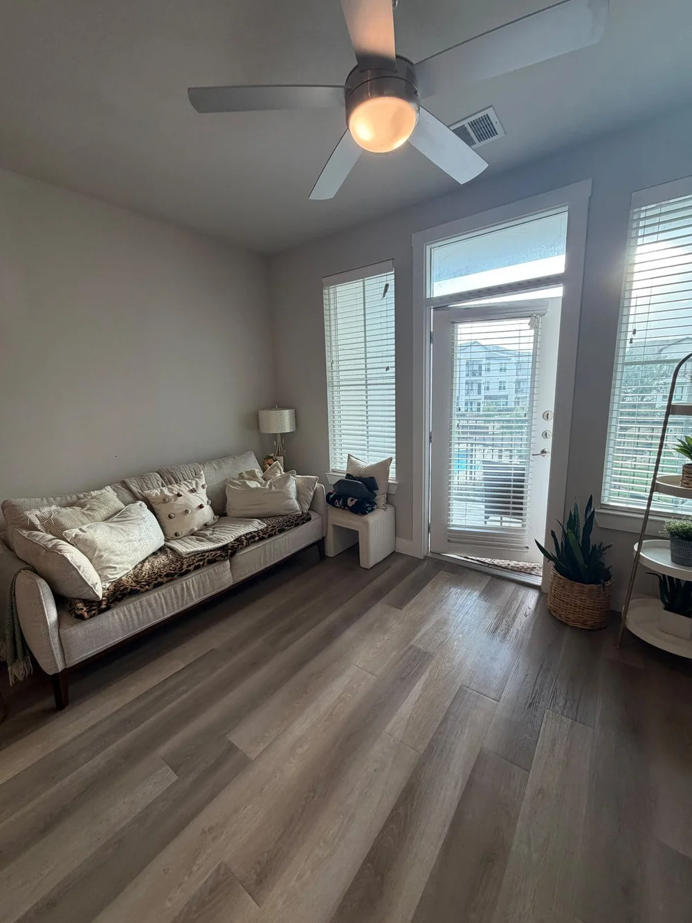 After: tidy living room with reset sofa and clean floors in an Austin apartment cleaned by Sparkly Maid Austin