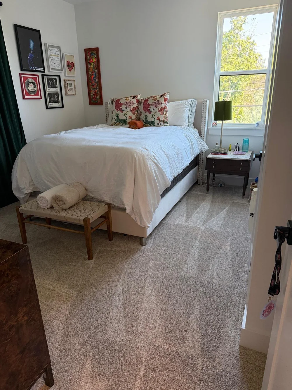 After: bed made with white linens and a cleared bench in an Austin bedroom cleaned by Sparkly Maid Austin