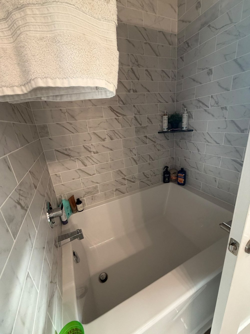 After: scrubbed bathtub and clean shower tile in an Austin home cleaned by Sparkly Maid Austin