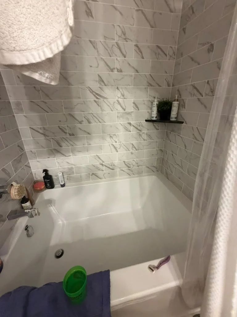 Before: bathtub with soap scum and scattered bath items in an Austin home