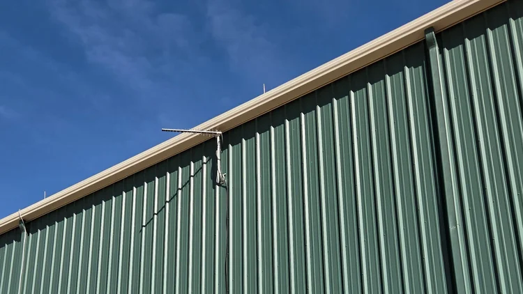 LPDA donor antenna mounted on a metal commercial building in North Texas