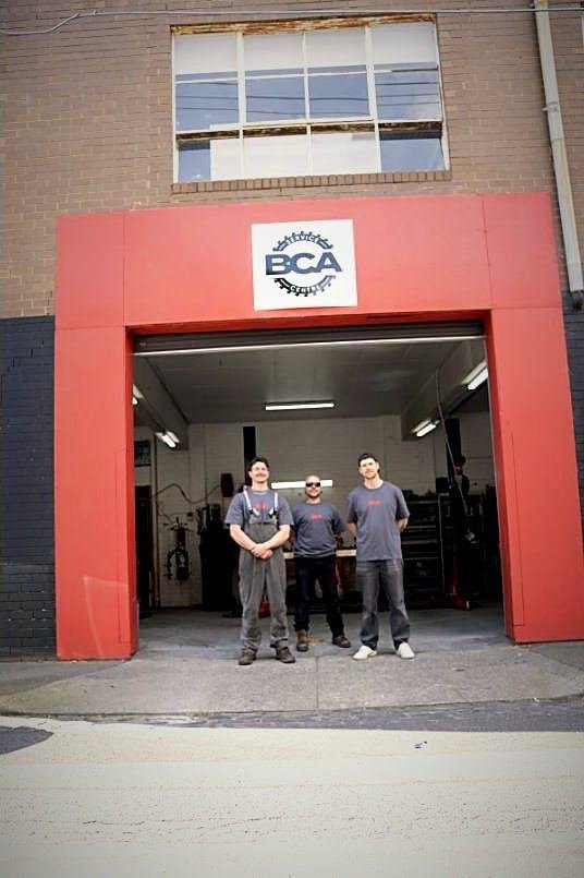 BCA mechanics outside the BCA Service Centre