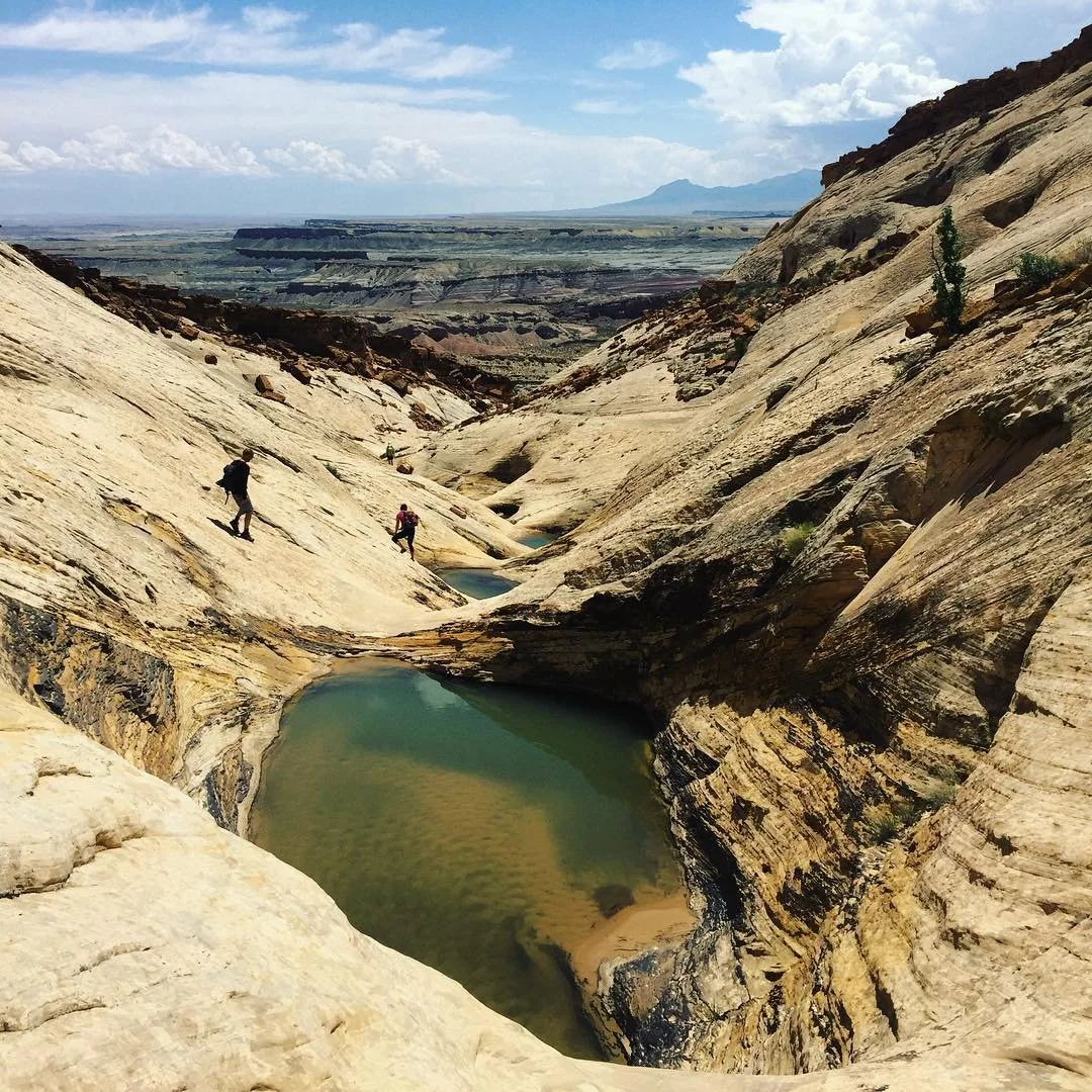 A desert canyon and pool in the San Rafael Swell