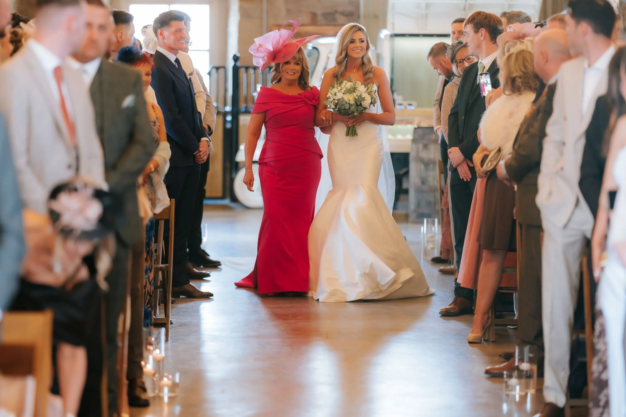Natalie arriving for the ceremony beside a woman in pink