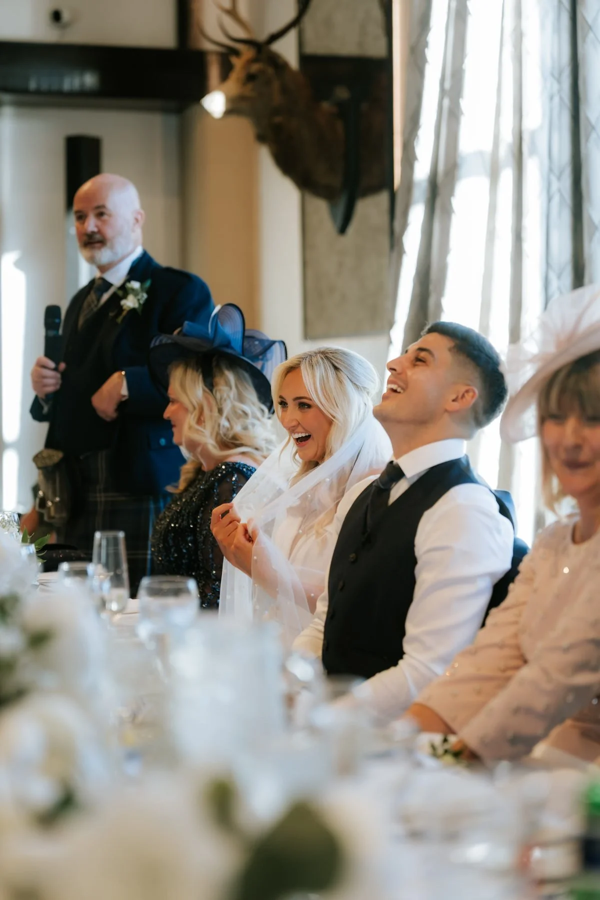 Lauren laughing alongside guests at the top table.