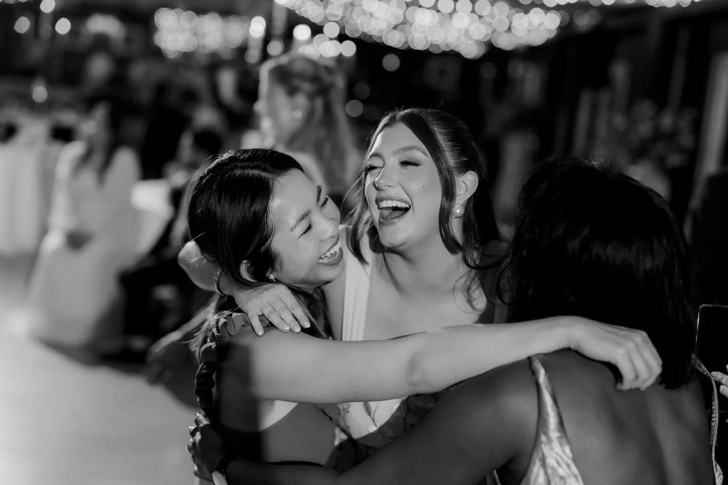 Guests singing and embracing on the dance floor.