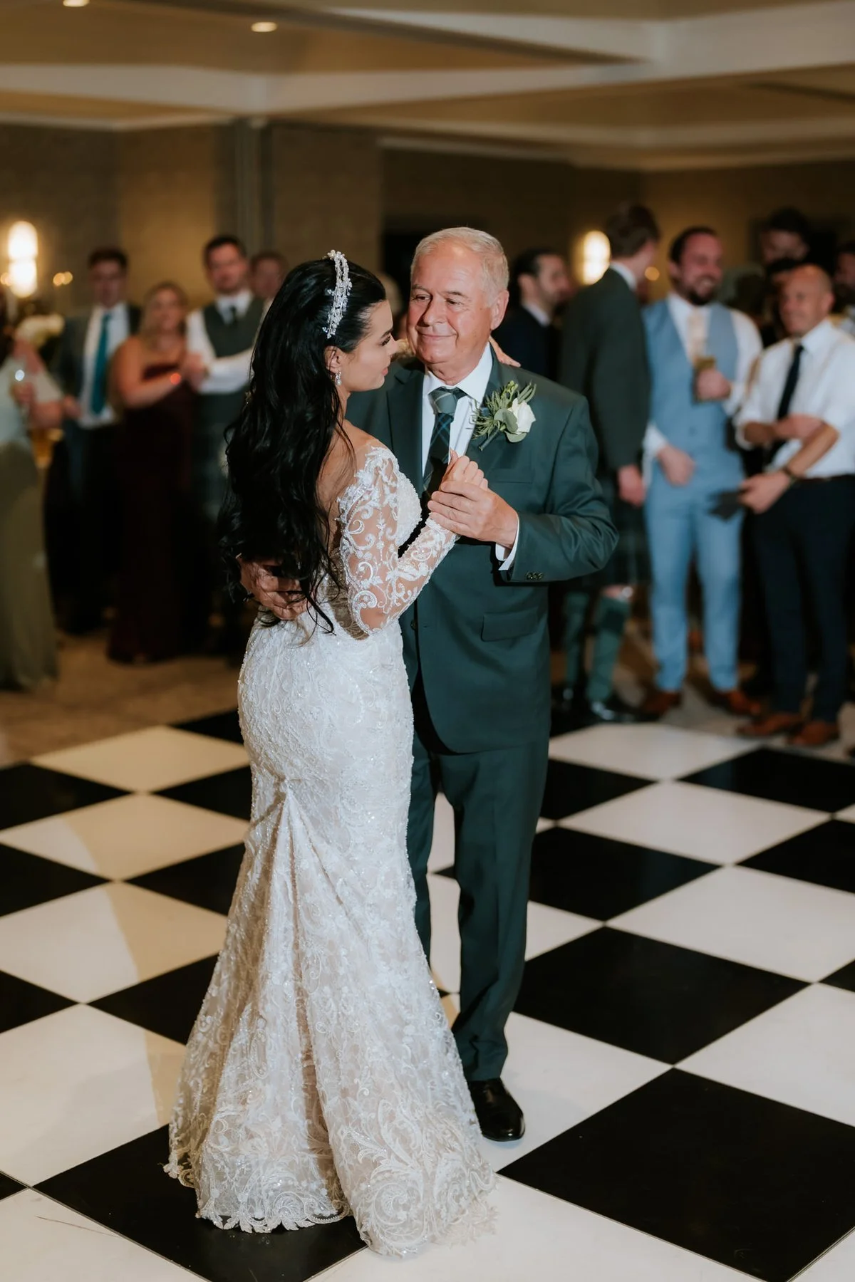Cristina sharing a dance as guests watch from the edge of the dance floor.