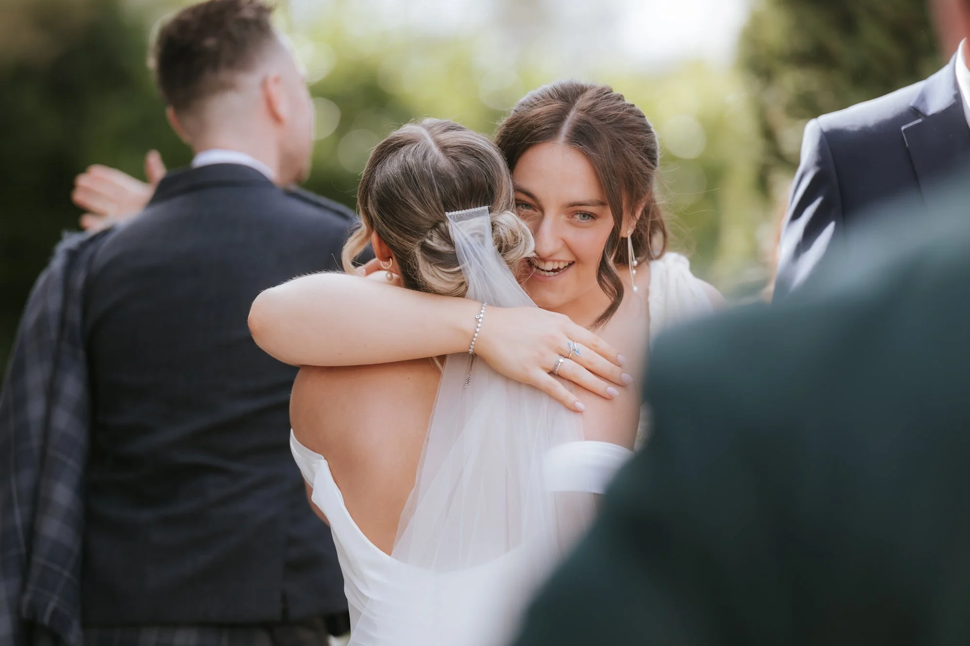 Elle embracing a young wedding guest