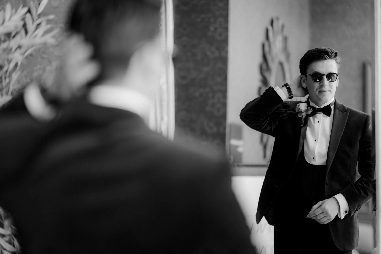 Jonathon checking his reflection in sunglasses as he gets ready.